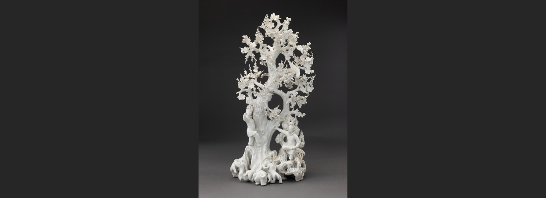 Dehua porcelain sculpture of a plum tree with figures around it