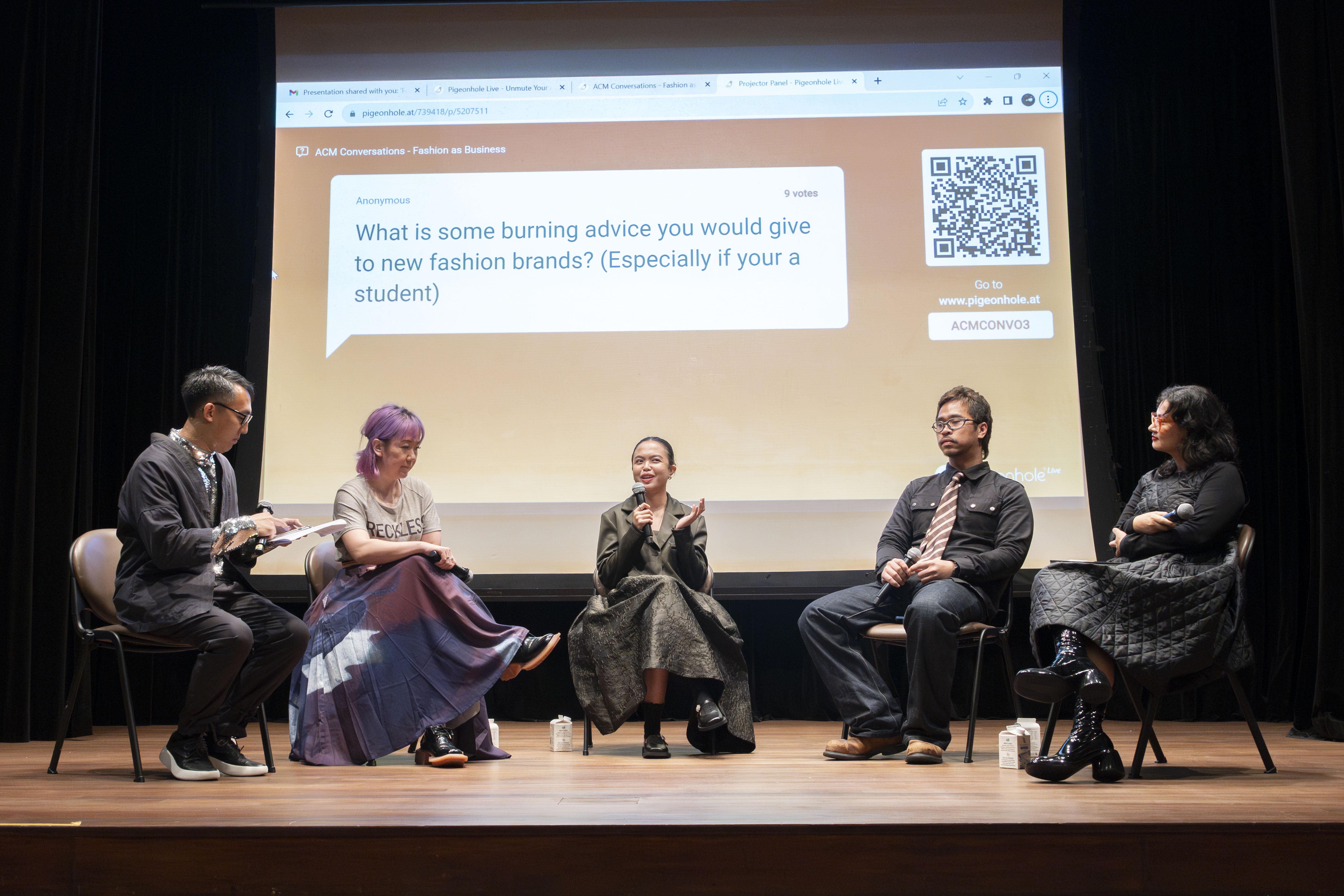 A group of speakers on stage