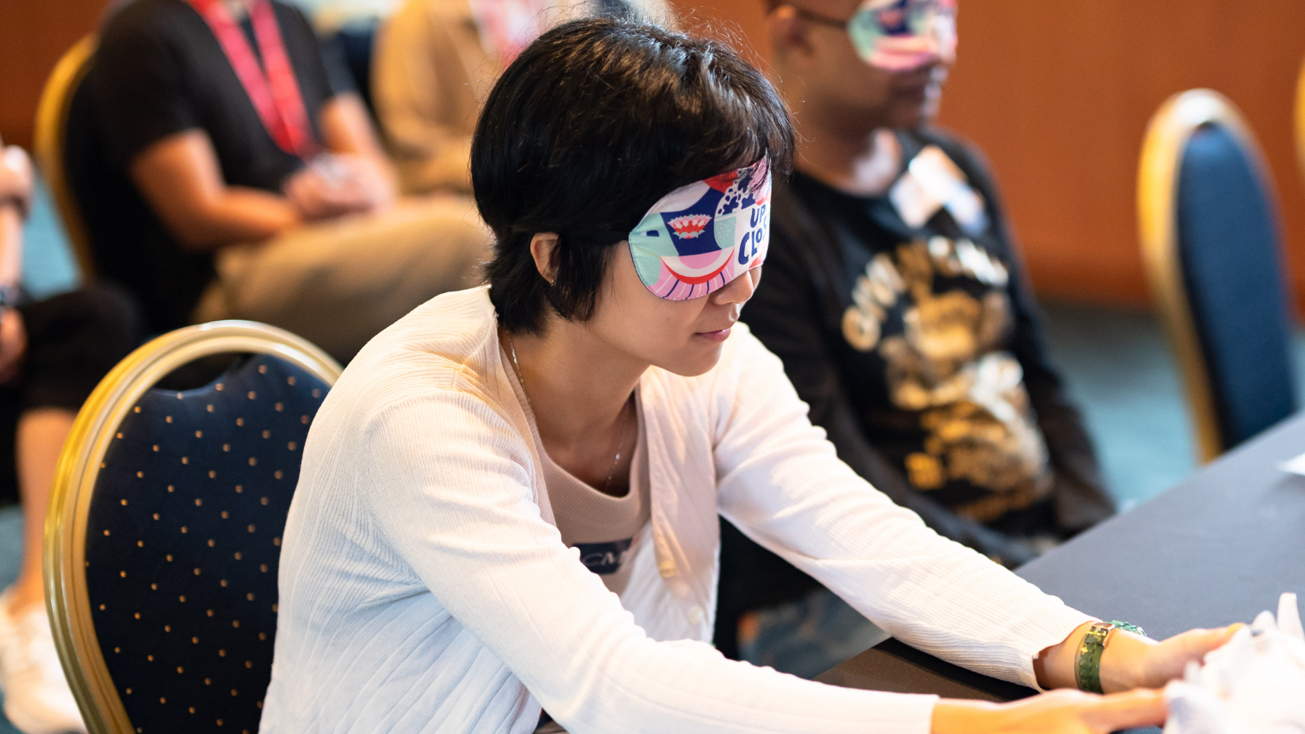 Blindfolded woman feeling a 3D printed object up close 