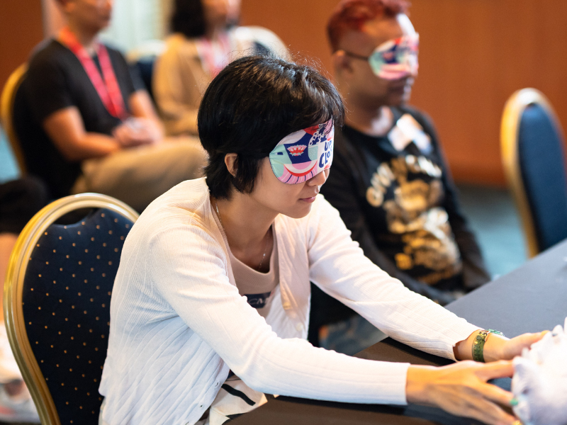 Blindfolded woman feeling a 3D printed object up close